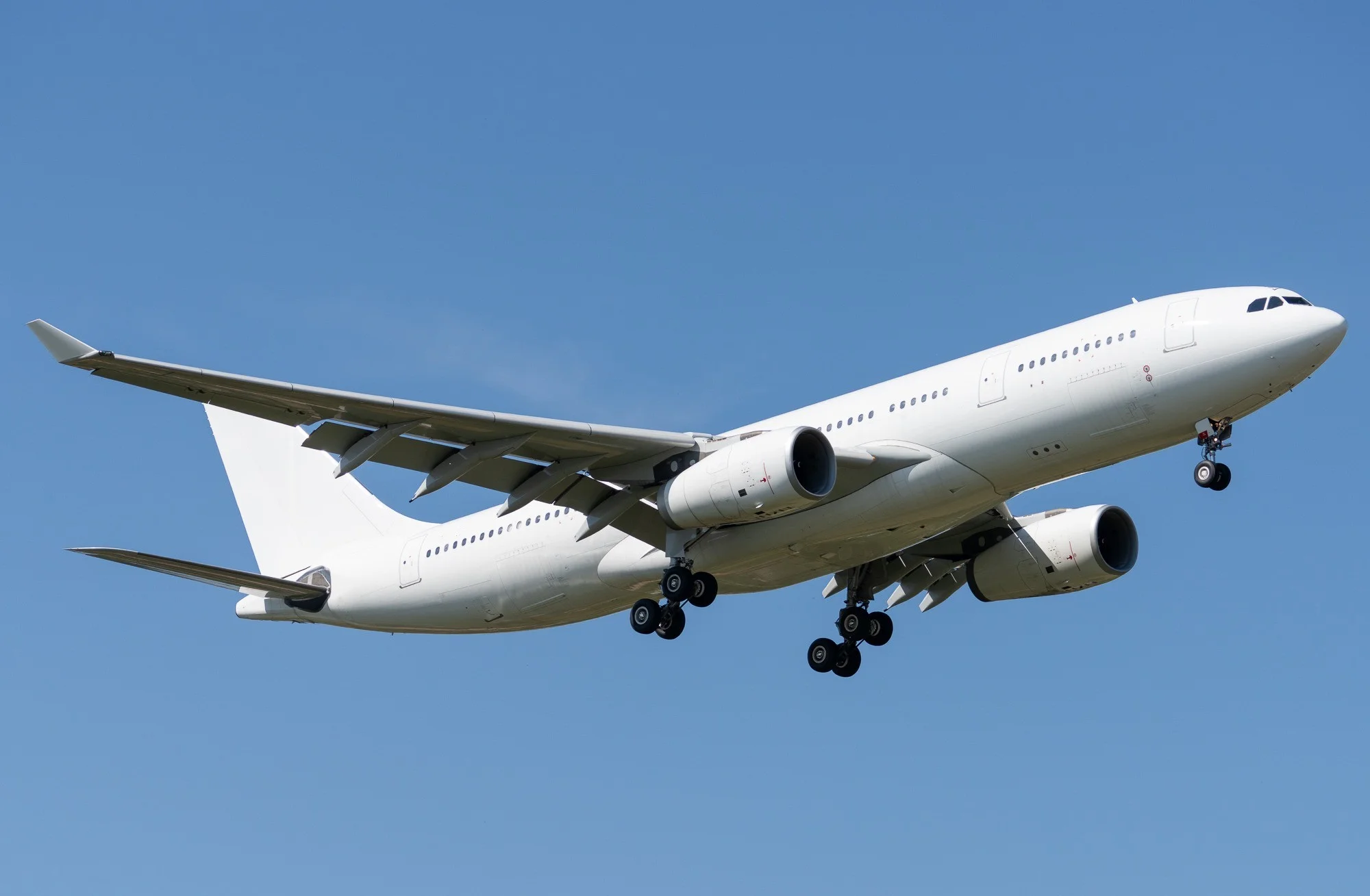 White Airbus A330 wide-body airliner in flight