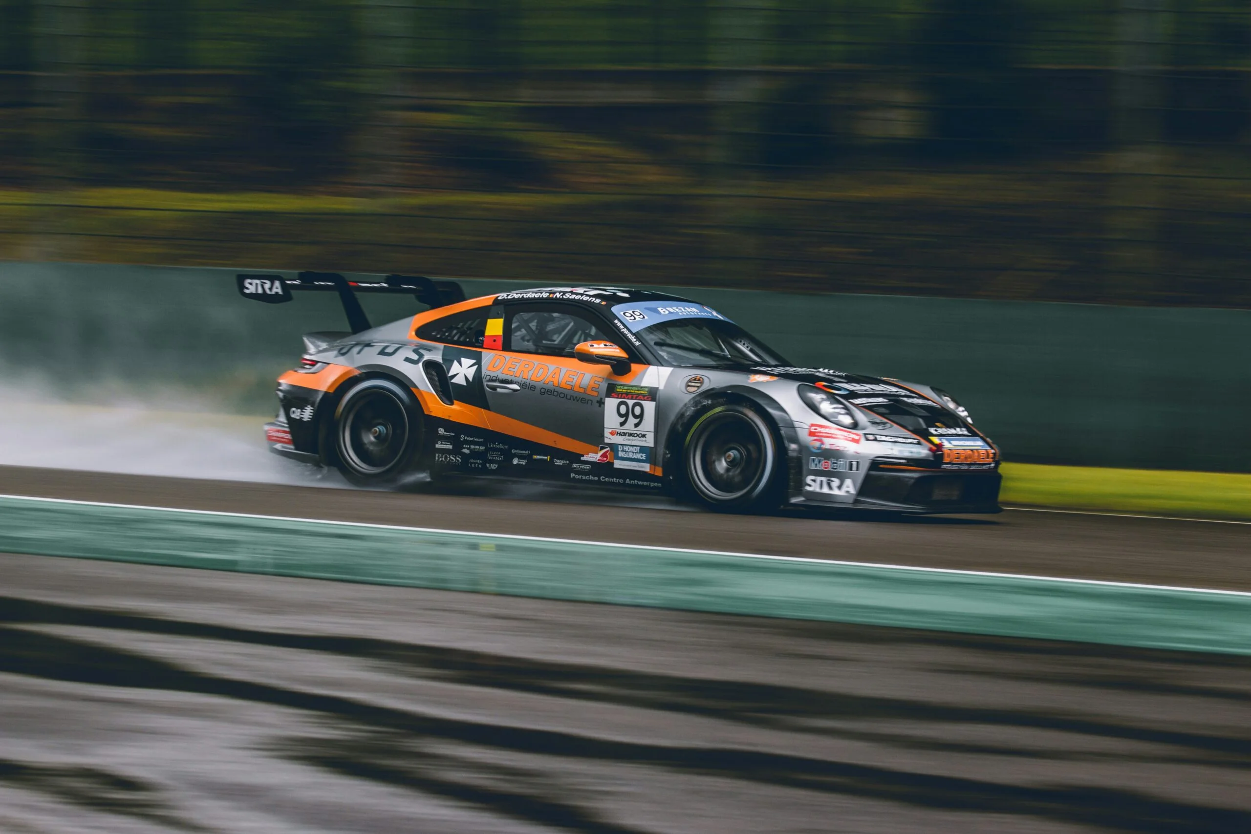 Sports car at speed on a wet track